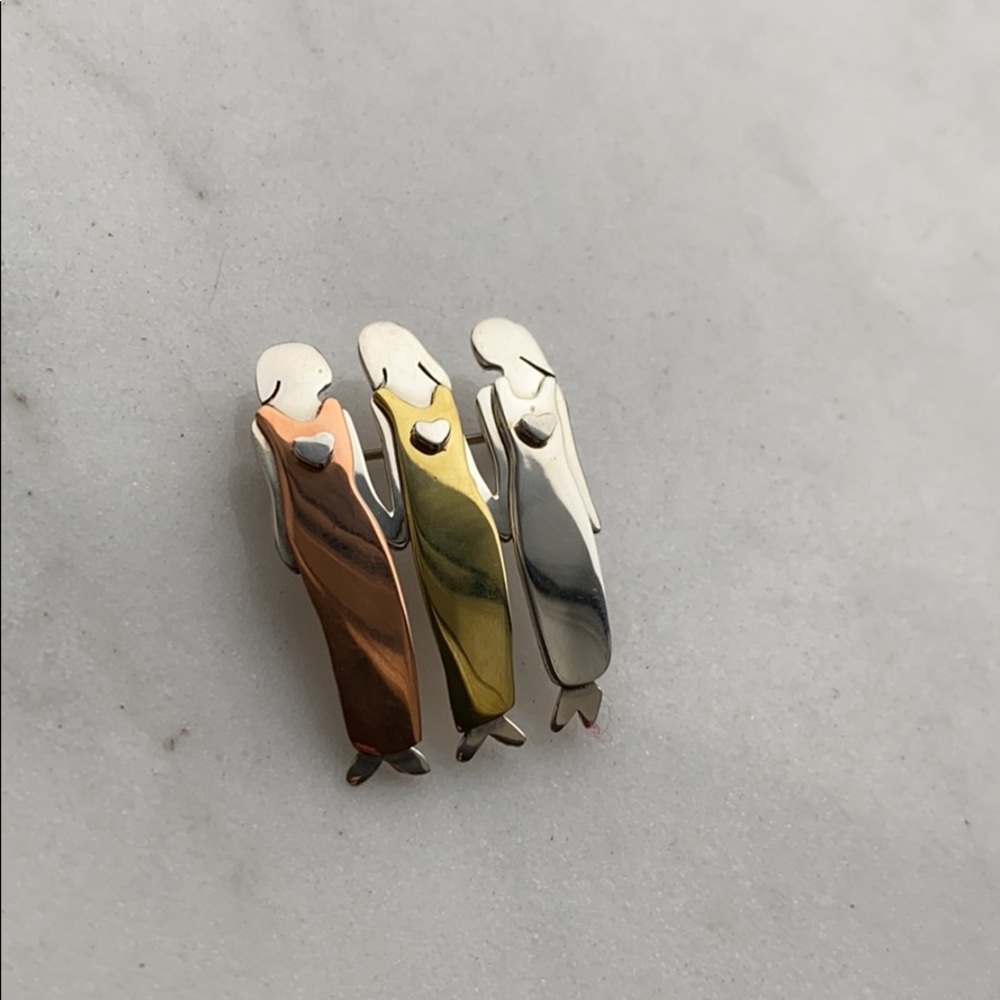 Three women holding hands pin